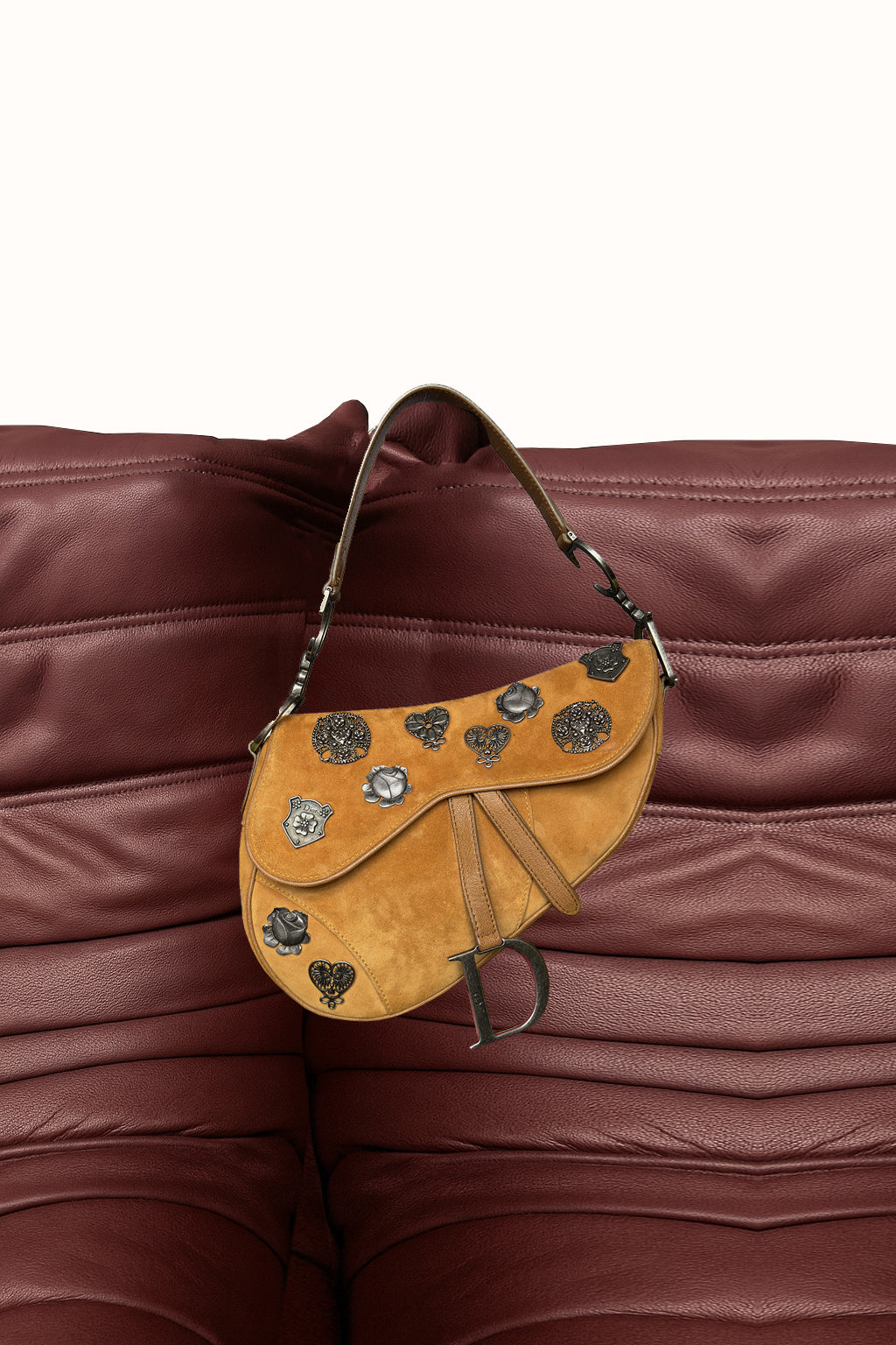 Brown leather saddle bag with decorative elements on a brown leather background